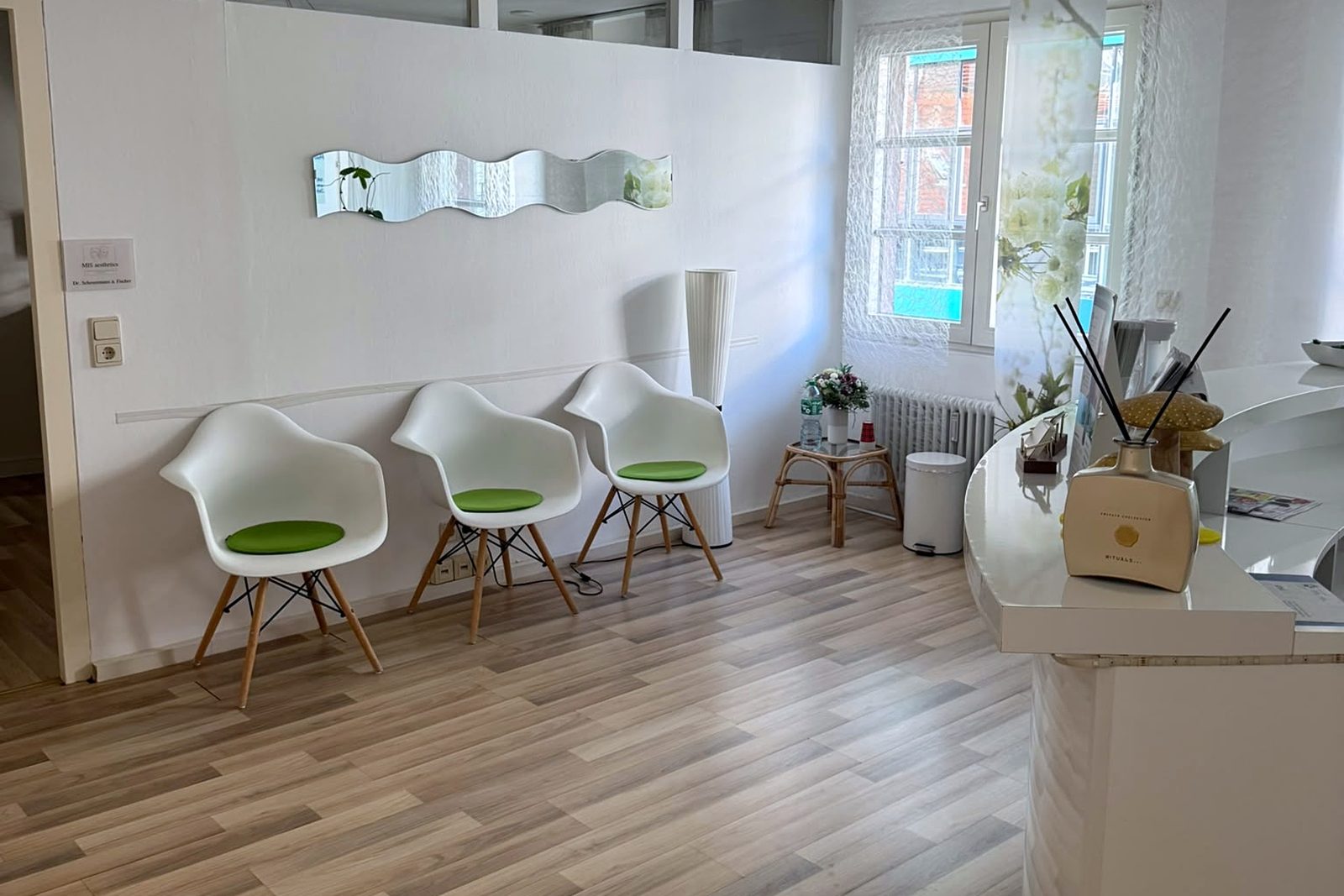 Reception with waiting area, light chairs and front desk